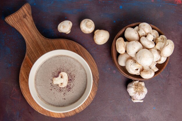 Top view delicious mushroom soup with mushrooms on dark desk