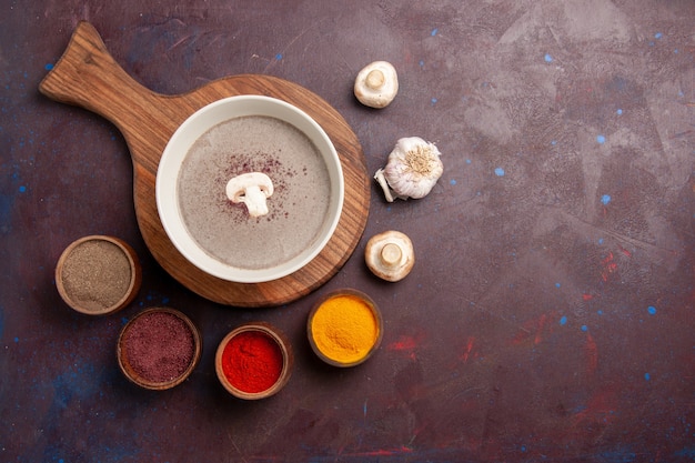 Top view delicious mushroom soup with seasonings on dark space