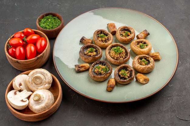 Top view delicious mushrooms meal with fresh greens and tomatoes on dark floor dish dinner meal cooking mushroom