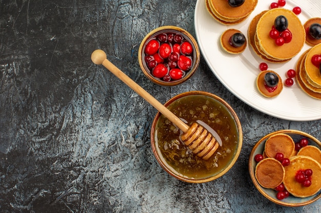 Top view on delicious pancakes with various ingredients