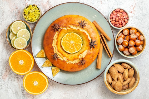 Free Photo top view delicious pie with nuts and fresh citrus fruits on white background fruit sweet nut cake pie biscuit