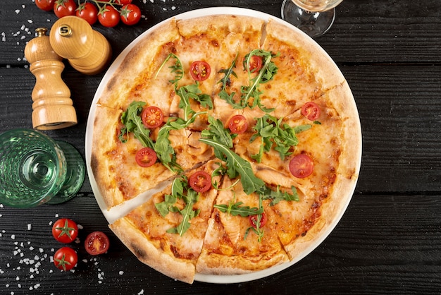 Top view of delicious pizza on wooden table