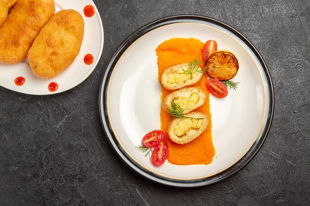 Top view delicious potato hotcakes with potato pie slices and pumpkin on dark background hotcake pie cake bake oven