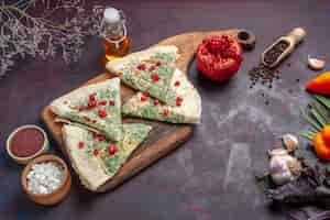 Free photo top view delicious qutabs cooked dough pieces with greens on a dark surface calorie fat cooking dish dough meal