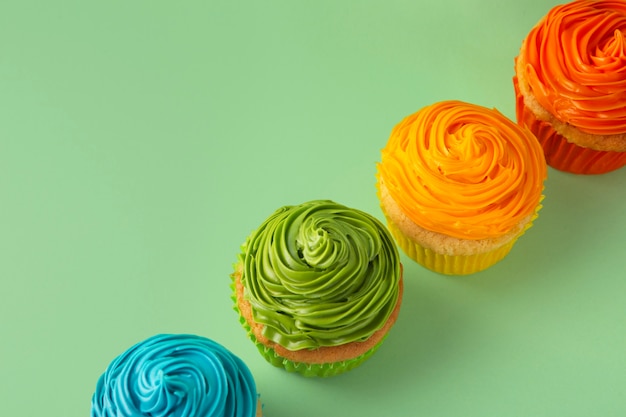 Free photo top view delicious rainbow cupcake glaze still life