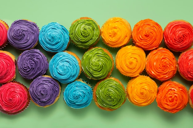 Free photo top view delicious rainbow cupcake glaze still life