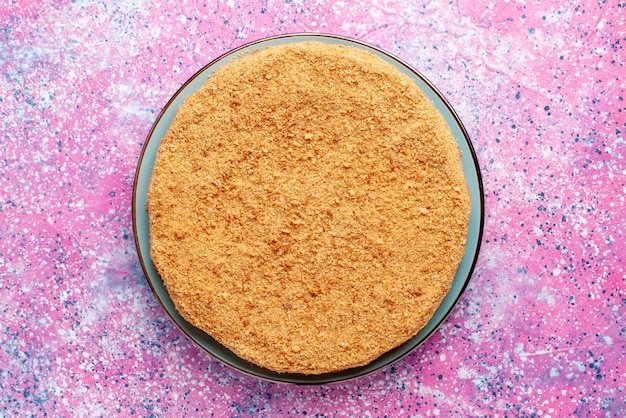 Top view delicious round cake inside glass plate on the bright desk cake pie biscuit sweet bake sugar