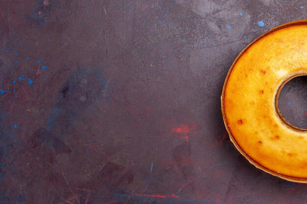 Top view delicious round cake perfect sweet pie for tea on dark desk tea sweet pie sugar dough cake