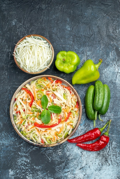 Free photo top view delicious salad with fresh vegetables on a grey background