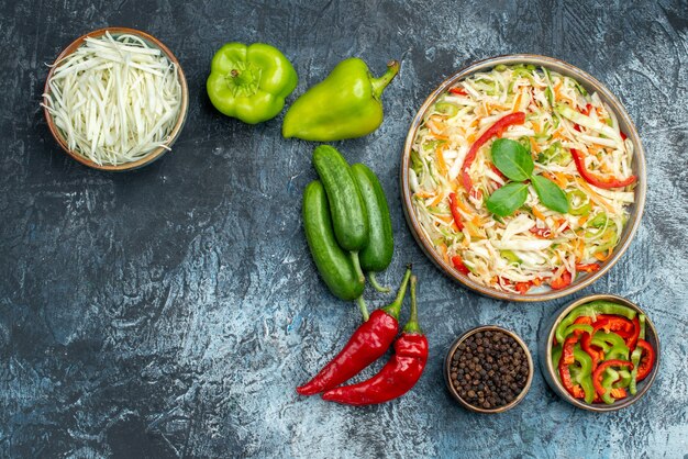 Top view delicious salad with fresh vegetables on light-grey background