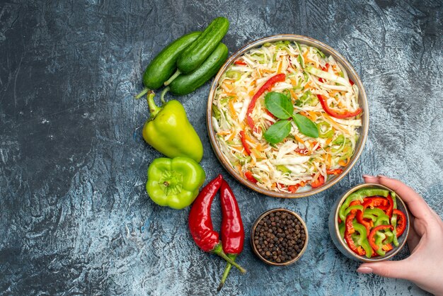 Top view delicious salad with fresh vegetables on light-grey background