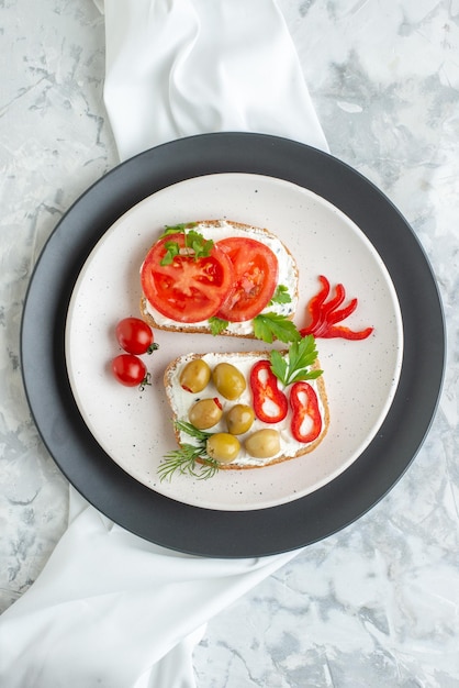 Top view delicious sandwiches with tomatoes and olives inside plate white background toast bread lunch burger horizontal meal food