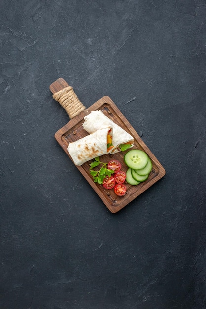 Free Photo top view delicious shawarma sliced pita sandwich on cutting board dark surface