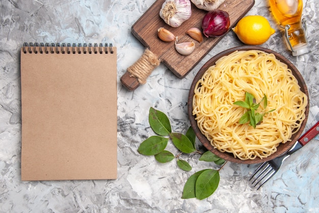 Free photo top view delicious spaghetti with garlic on a white table dinner dough meal pasta