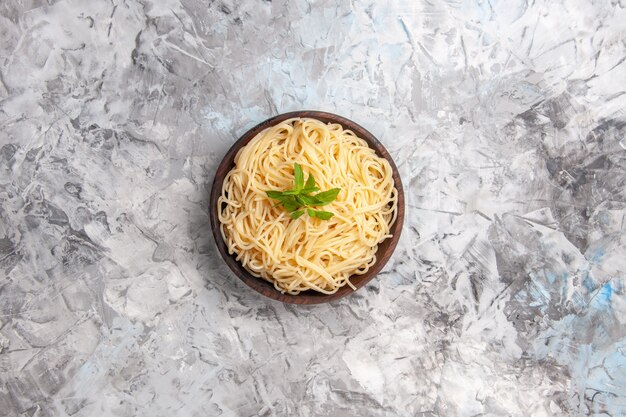 Top view delicious spaghetti with green leaf on a white table dish pasta meal dough