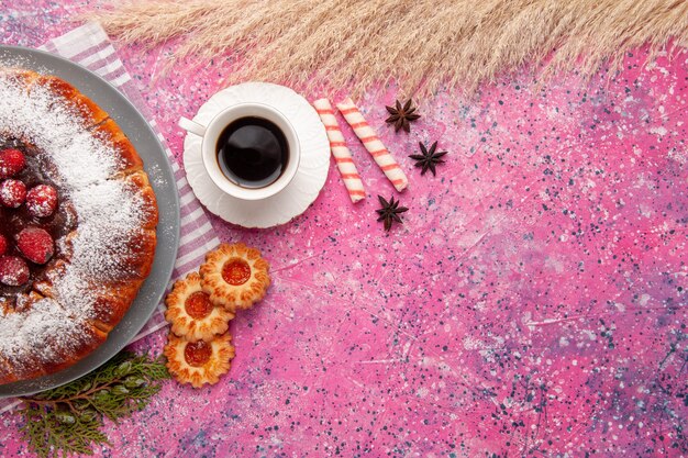 Top view delicious strawberry cake sugar powdered with cookies and tea on light-pink background cake sweet biscuit cookie tea