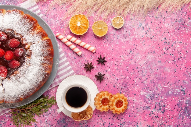 Top view delicious strawberry cake sugar powdered with cookies and tea on light-pink background cake sweet sugar biscuit cookies tea