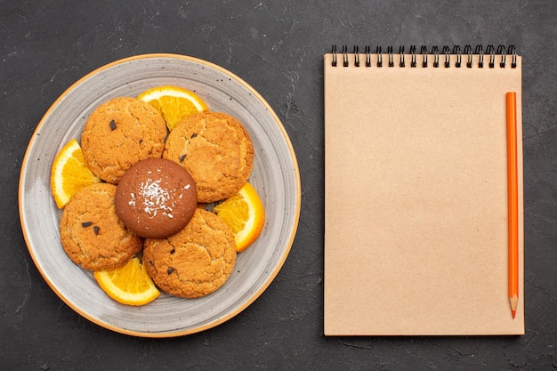 Free photo top view delicious sugar cookies with fresh sliced oranges on a dark background sugar biscuit sweet cookie fruit