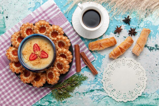 Top view delicious sugar  with cup of coffee bagels and strawberry dessert on blue surface