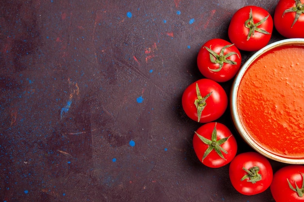 Free Photo top view delicious tomato soup circled with fresh red tomatoes on the dark background tomato soup meal dish sauce