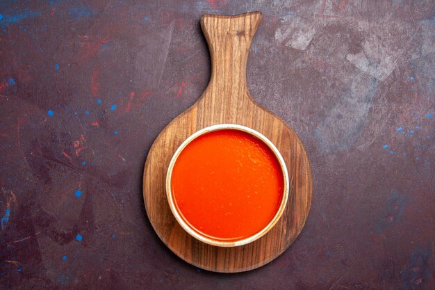 Top view delicious tomato soup cooked from fresh red tomatoes on dark background tomato soup meal dish sauce