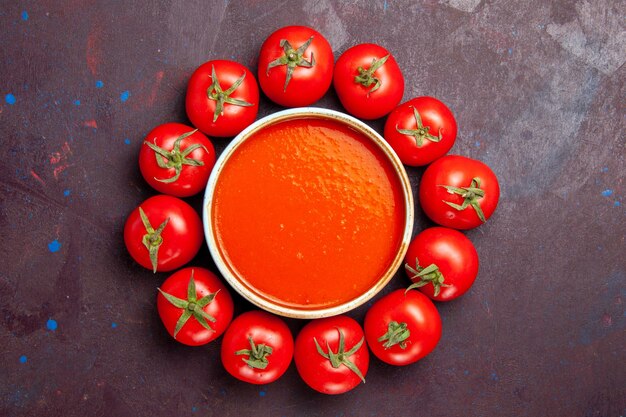 Top view delicious tomato soup with fresh tomatoes on dark background tomatoes dish dinner soup sauce meal