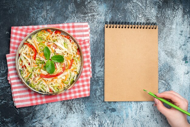 Top view delicious vegetable salad inside tray on light-grey background