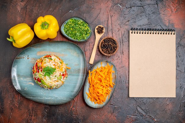 Top view delicious vegetable salad with greens and carrot on a dark background color ripe food meal healthy life photo