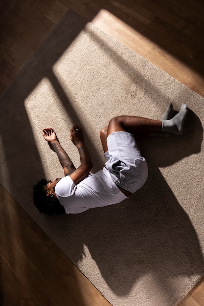 Free photo top view depressed man laying on floor