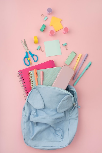 Top view desk arrangement with backpack