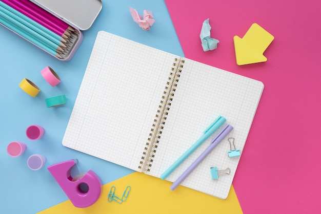 Top view desk arrangement with open notebook