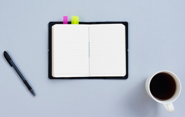 Top view desk concept with blank notepad 