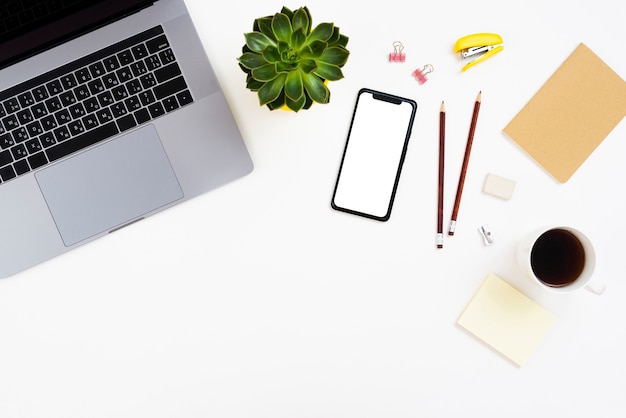 Top view desk concept with mock-up smartphone