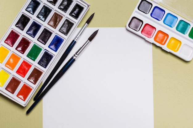 Top view of desk concept with paint and copy space