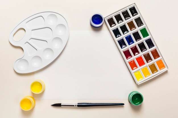 Top view of desk concept with paint and copy space