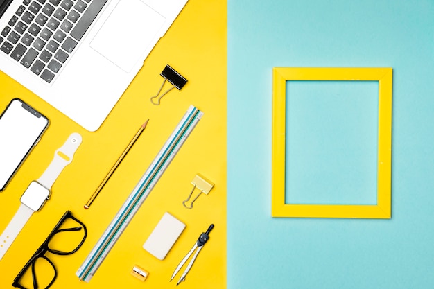 Free photo top view desk concept with yellow frame