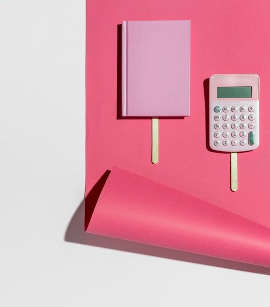 Free photo top view desk minimal pink notebook and calculator