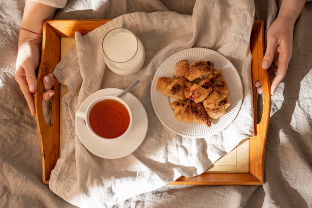 Free photo top view of desserts on tray with tea and milk