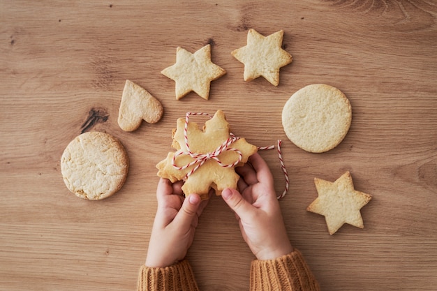 Top view detail of cookies held by hands of child