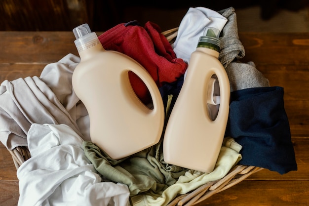 Free photo top view detergent bottles and clothes