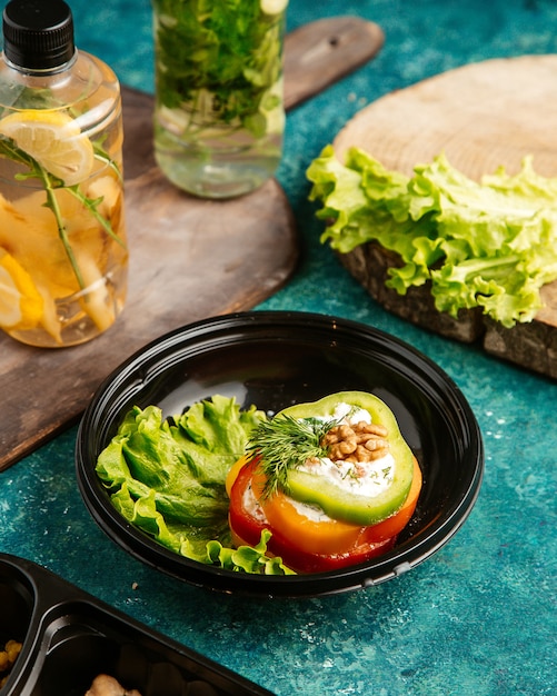 Free Photo top view diet food multi-colored bell peppers on lettuce with walnut and detox water