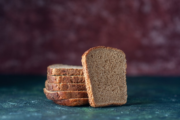 Free photo top view of dietary black bread slices on mixed colors background with free space