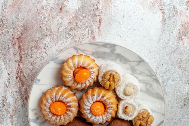 Top view different cakes little sweets on a white background tea cookie biscuit sugar sweet cake