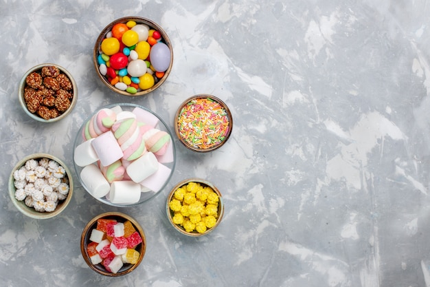 Free Photo top view different colorful candies with marmalade on the white desk