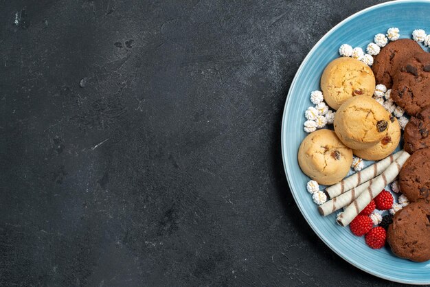 Top view different cookies sweet inside  on grey surface