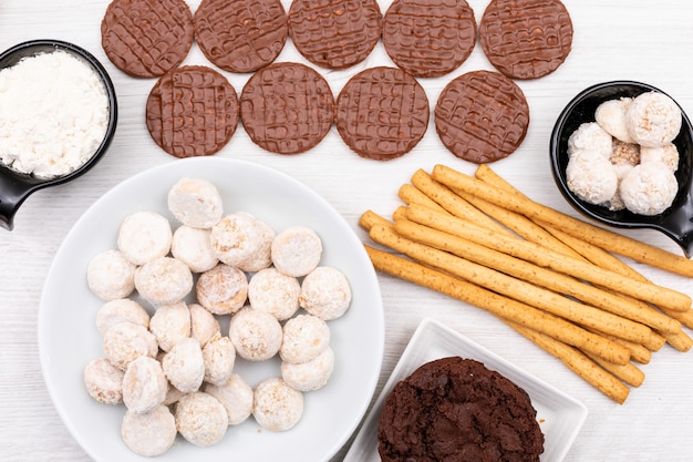 Top view different cookies on white table