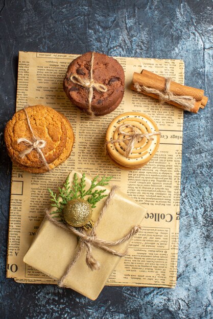 Top view different delicious biscuits with present on light background