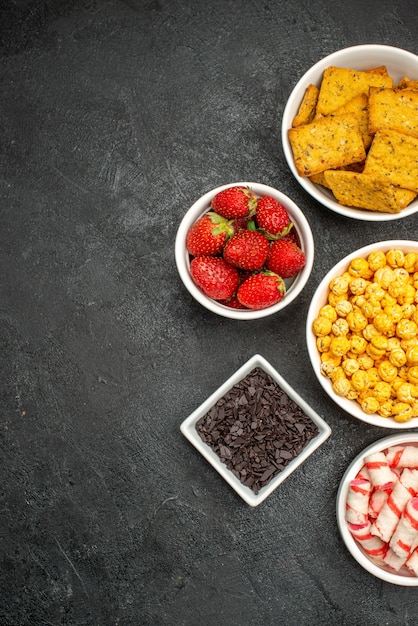 Top view different eatings crisps fruits and candies