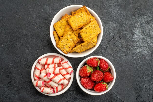 Top view different eatings crisps fruits and candies