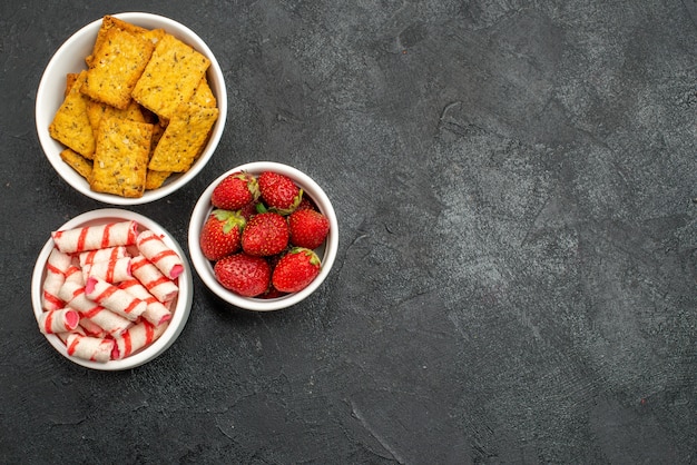 Top view different eatings crisps fruits and candies